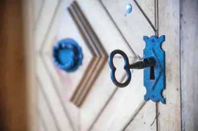 a door with a blue key hanging on it at Hiška sončni hrib. in Novo Mesto