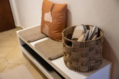 a basket sitting on a table next to a couch at Hiška sončni hrib. in Novo Mesto