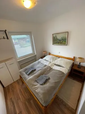 a bedroom with a bed with two towels on it at Riverhouse apartment in Radovljica