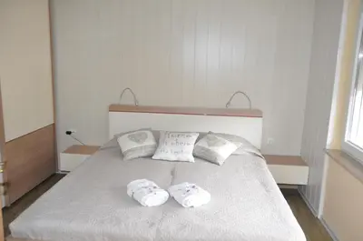 a bedroom with a bed with two towels on it at Apartment Maruška in Tolmin