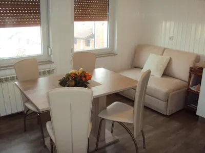 a living room with a table and a couch at Apartment Maruška in Tolmin