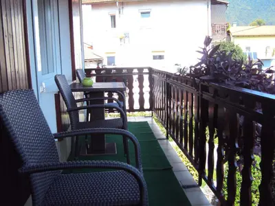 a patio with two chairs and a table on a balcony at Apartment Maruška in Tolmin