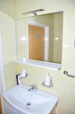 a bathroom with a sink and a mirror at Apartment Maruška in Tolmin
