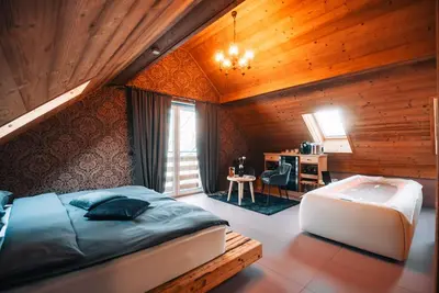 a bedroom with a bed and a tub in a room at Posest Kunigunda in Šmartno v Rožni Dolini