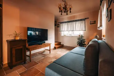 a living room with a couch and a flat screen tv at Posest Kunigunda in Šmartno v Rožni Dolini