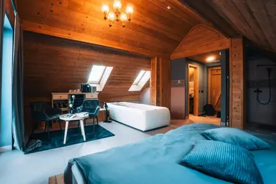 a bedroom with a large bed and a desk at Posest Kunigunda in Šmartno v Rožni Dolini
