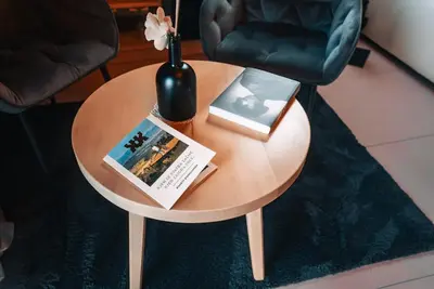 a round table with a vase and books on it at Posest Kunigunda in Šmartno v Rožni Dolini