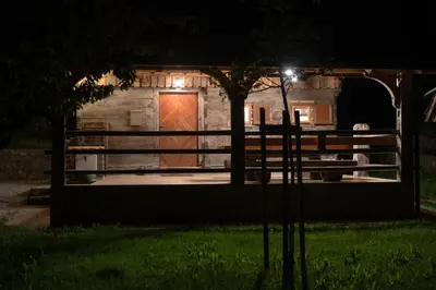 a building with a large door at night at MARRYS APARTMENTS in Polica