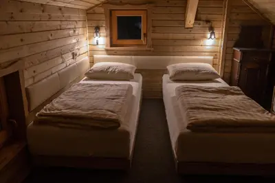 a room with two beds in a wooden cabin at MARRYS APARTMENTS in Polica