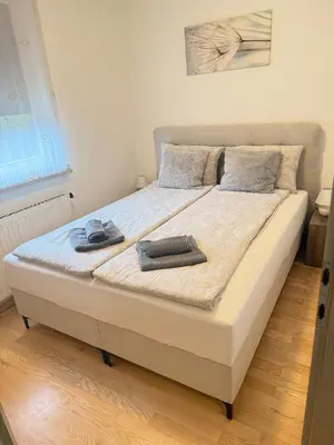 a bed with two towels on it in a bedroom at Apartma Galjevica in Ljubljana