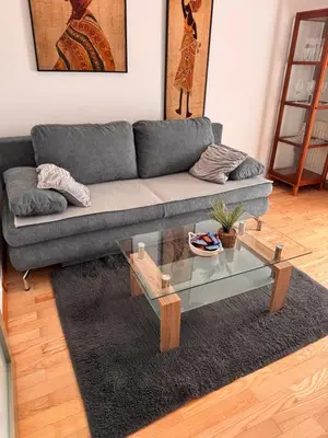 a living room with a couch and a glass coffee table at Apartma Galjevica in Ljubljana