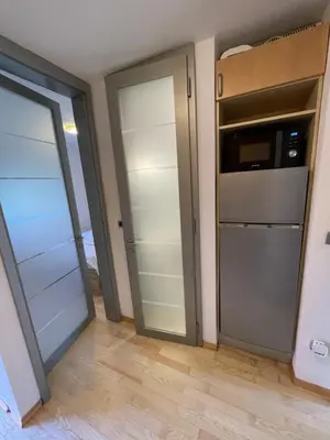 a room with two glass doors and a kitchen at Apartma Galjevica in Ljubljana