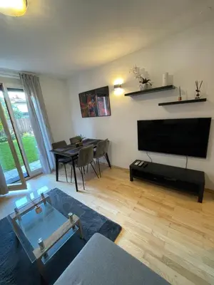 a living room with a television and a dining room table at Apartma Galjevica in Ljubljana