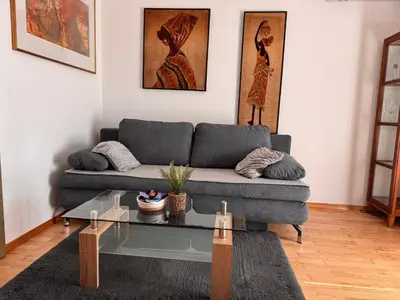 a living room with a couch and a glass table at Apartma Galjevica in Ljubljana