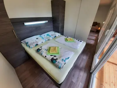 a small bed in a small room with two pillows at Chalet and Apartment Žonir with SAUNA in Kobarid