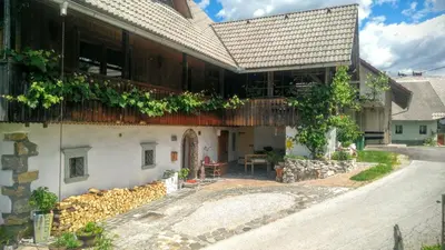 a house with a wooden roof and a patio at Apartment Sonca in Bled