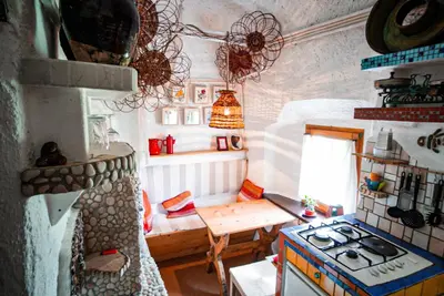 a small kitchen with a stove and a table at Apartment Sonca in Bled