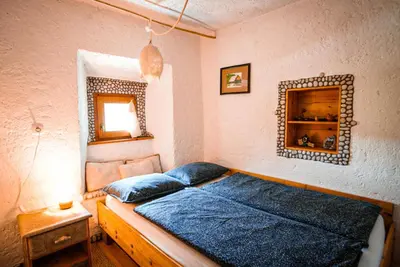 a bedroom with a bed and a mirror on the wall at Apartment Sonca in Bled