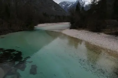 a river with green water and mountains in the background at Apartment Bon in Kobarid