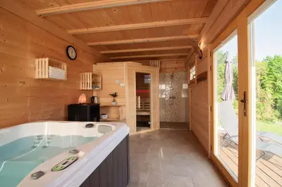 a bathroom with a tub and a large window at Apartment Bon in Kobarid