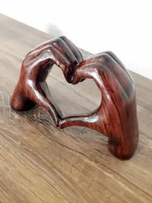 a wooden heart shaped object sitting on a table at Apartmaji Brložnica pod Veliko planino in Luče