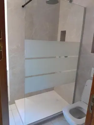 a bathroom with a shower and a toilet at Deluxe Central Apartment in Ljubljana