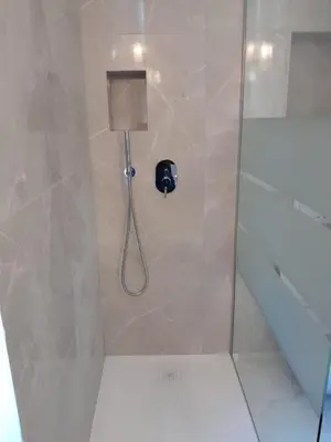 a bathroom with a shower with a phone in it at Deluxe Central Apartment in Ljubljana