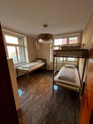 a room with two bunk beds and two windows at Deluxe Central Apartment in Ljubljana