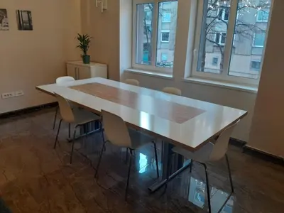 a table in an office with chairs around it at Deluxe Central Apartment in Ljubljana