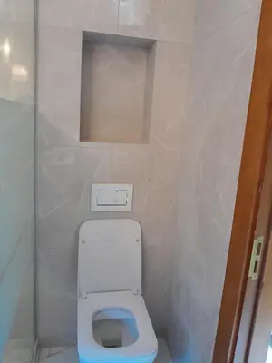 a small bathroom with a white toilet in a room at Deluxe Central Apartment in Ljubljana
