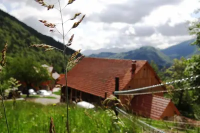 a barn in a field with mountains in the background at Stunning Hills View Apartment Vransko in Vransko