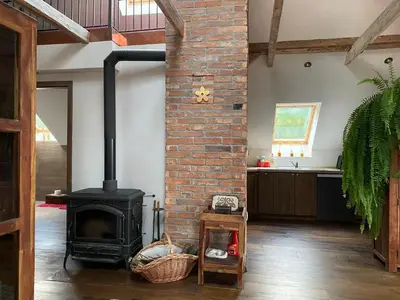 a brick fireplace in a living room with a stove at Stunning Hills View Apartment Vransko in Vransko