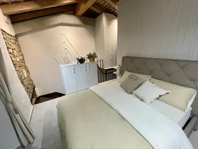 a bedroom with a large white bed with pillows at Vila Imenja in Šmartno