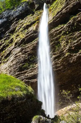a waterfall on the side of a rock formation at Apartma Juniper in Kranjska Gora