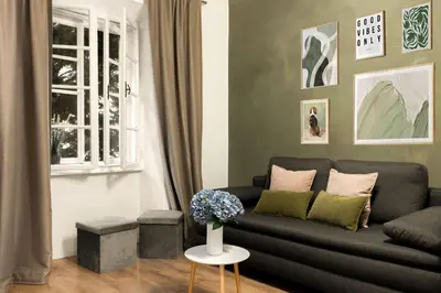 a living room with a couch and a window at Cosy Castle Flat in Ljubljana Center - FREE PARKING in Ljubljana