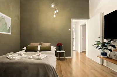 a bedroom with a bed and a flat screen tv at Cosy Castle Flat in Ljubljana Center - FREE PARKING in Ljubljana