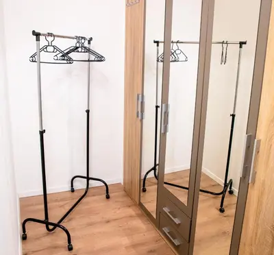 a mirror in a room with two metal stands at Cosy Castle Flat in Ljubljana Center - FREE PARKING in Ljubljana