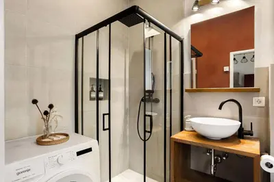 a bathroom with a shower and a white sink at Cosy Castle Flat in Ljubljana Center - FREE PARKING in Ljubljana