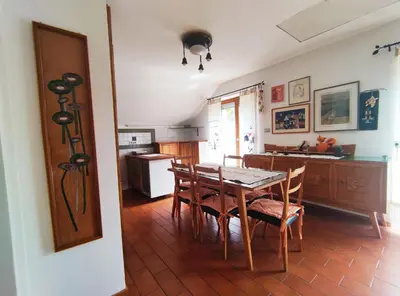 a kitchen and dining room with a table and chairs at Apartments Leni in Postojna