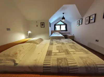 a large bed in a room with two beds at Apartments Leni in Postojna