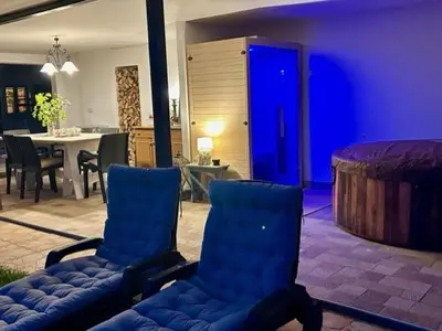 a living room with two blue chairs and a table at Kraska nisa in Komen