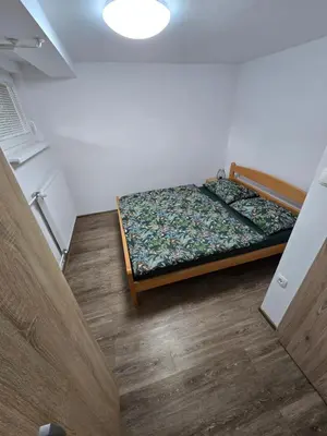 a small bedroom with a bed in a room at Apartments Boldin in Bled