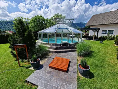 a swimming pool with a gazebo in a yard at Apartments Boldin in Bled