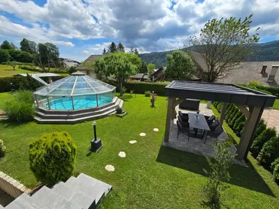 an overhead view of a backyard with a pool and a pavilion at Apartments Boldin in Bled