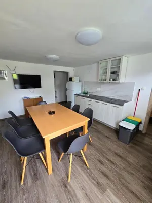 a room with a table and chairs and a kitchen at Apartments Boldin in Bled