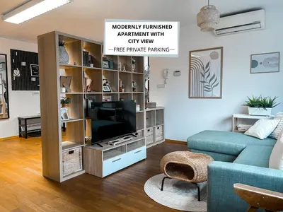 a living room with a tv in a entertainment center at Spacious Cozy apartment in Ljubljana