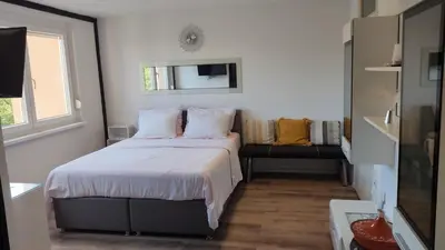 a small bedroom with a bed and a window at Apartma Vas in Maribor