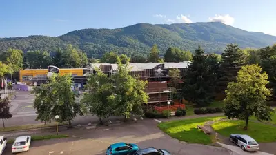 a parking lot with cars parked in front of a building at Apartma Vas in Maribor