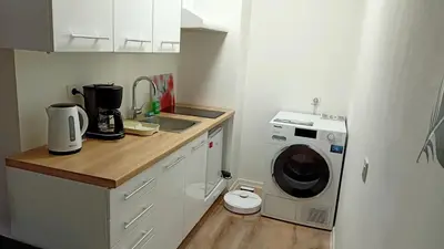 a kitchen with a washing machine and a washer at Apartma Vas in Maribor