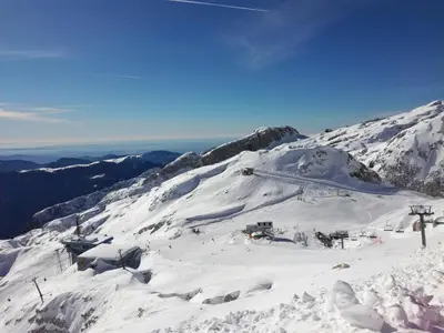 a snow covered mountain with a ski lift on it at Apartments Dvor in Bovec